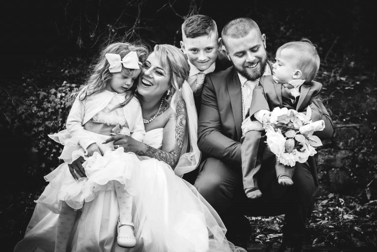 Bride and groom having a fun moment with their energetic bridal party.