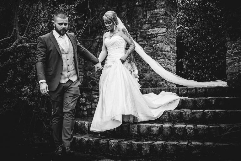 Bride and groom holding hands and exchanging heartfelt vows during the wedding ceremony.