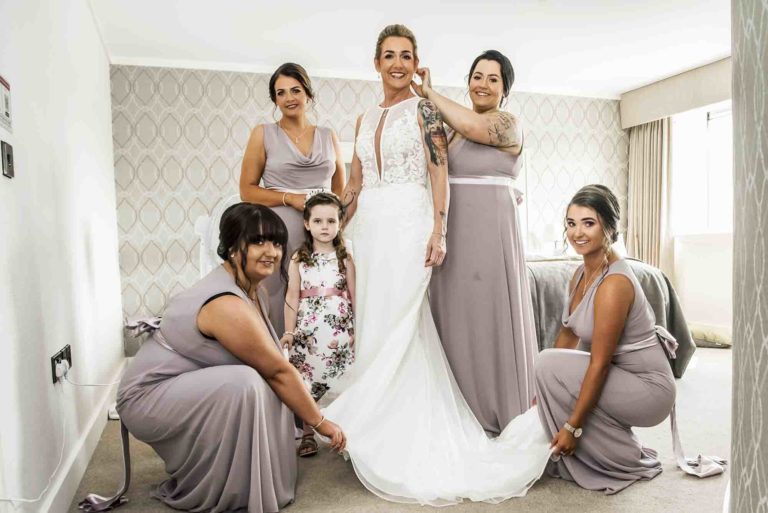 Capturing the bond: Bride and bridesmaids walking side by side.