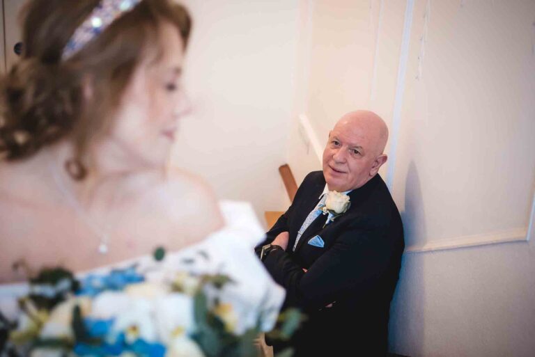 Beautiful bride and handsome groom smiling at each other during their wedding day.