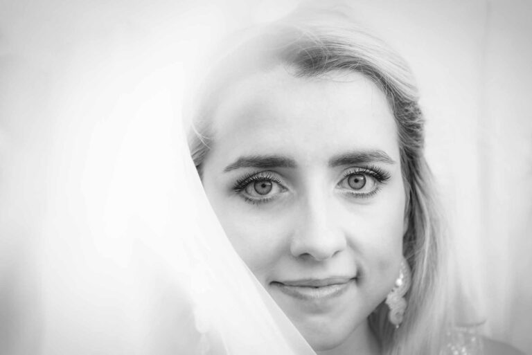 Beautiful bride looking at camera lense during her wedding day.